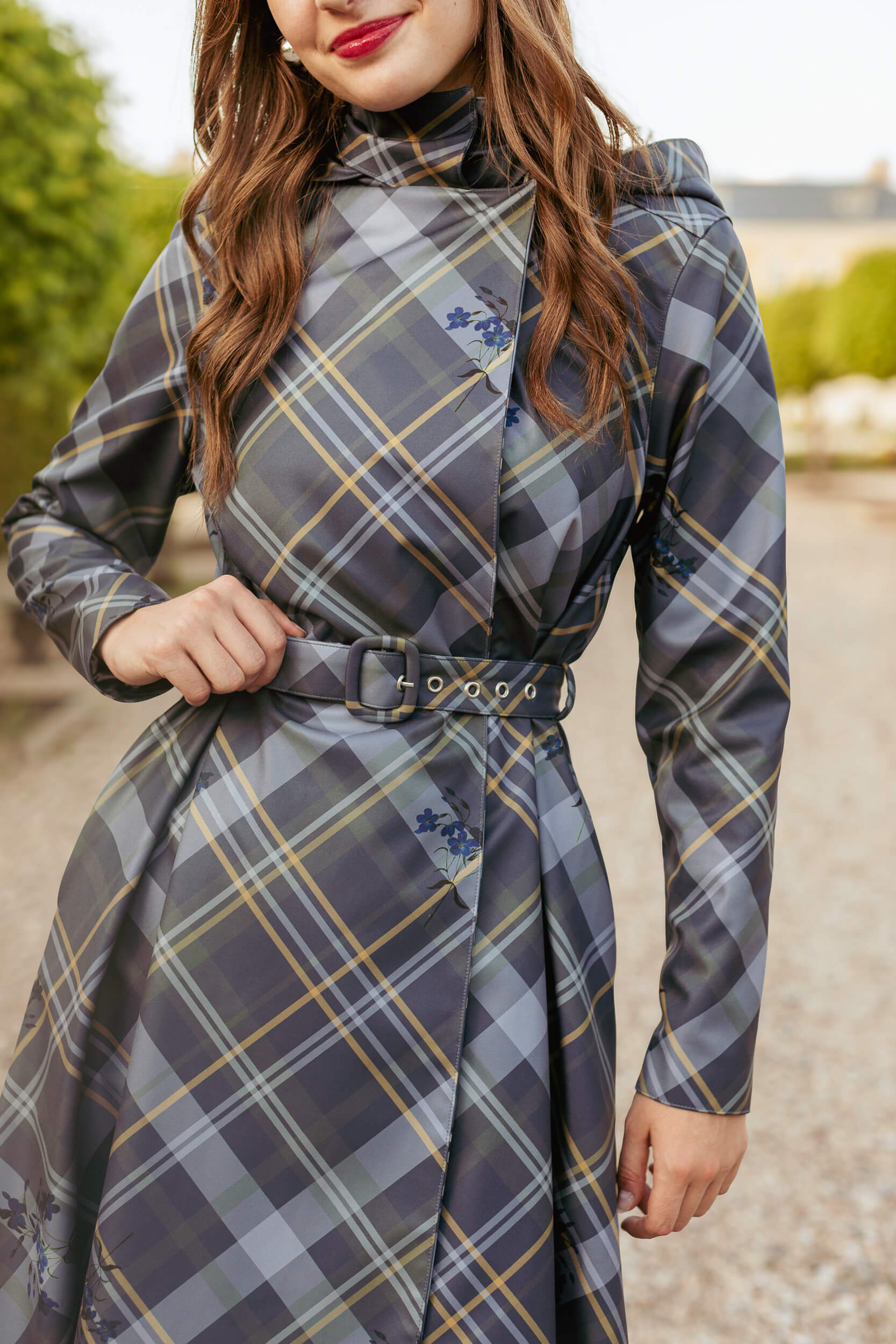 Model wearing Duchess in Blue coat with belt tied, showing flattering fit.