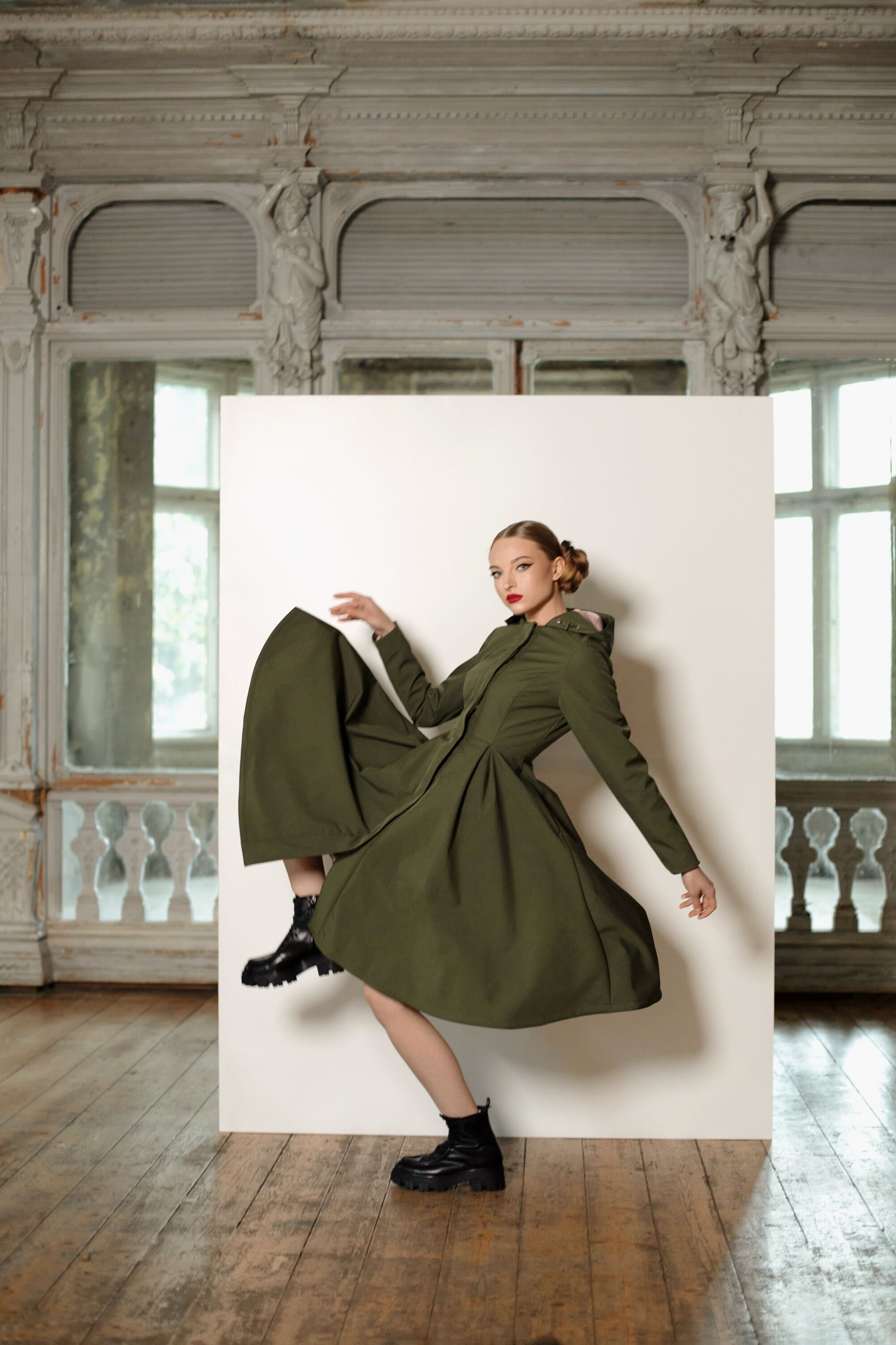 RainSisters Moss Green coat showing adjustable hood, hidden side pockets, and flattering silhouette on model 1.73m tall