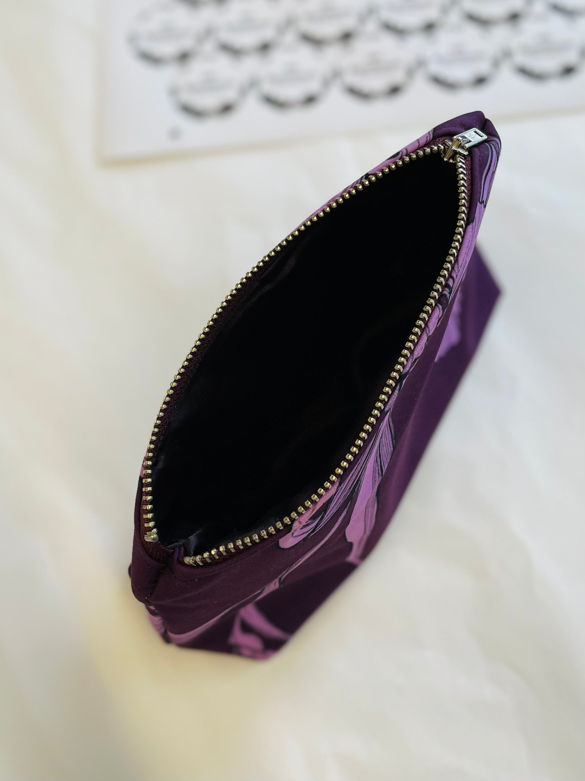 purple floral makeup bag with black lining