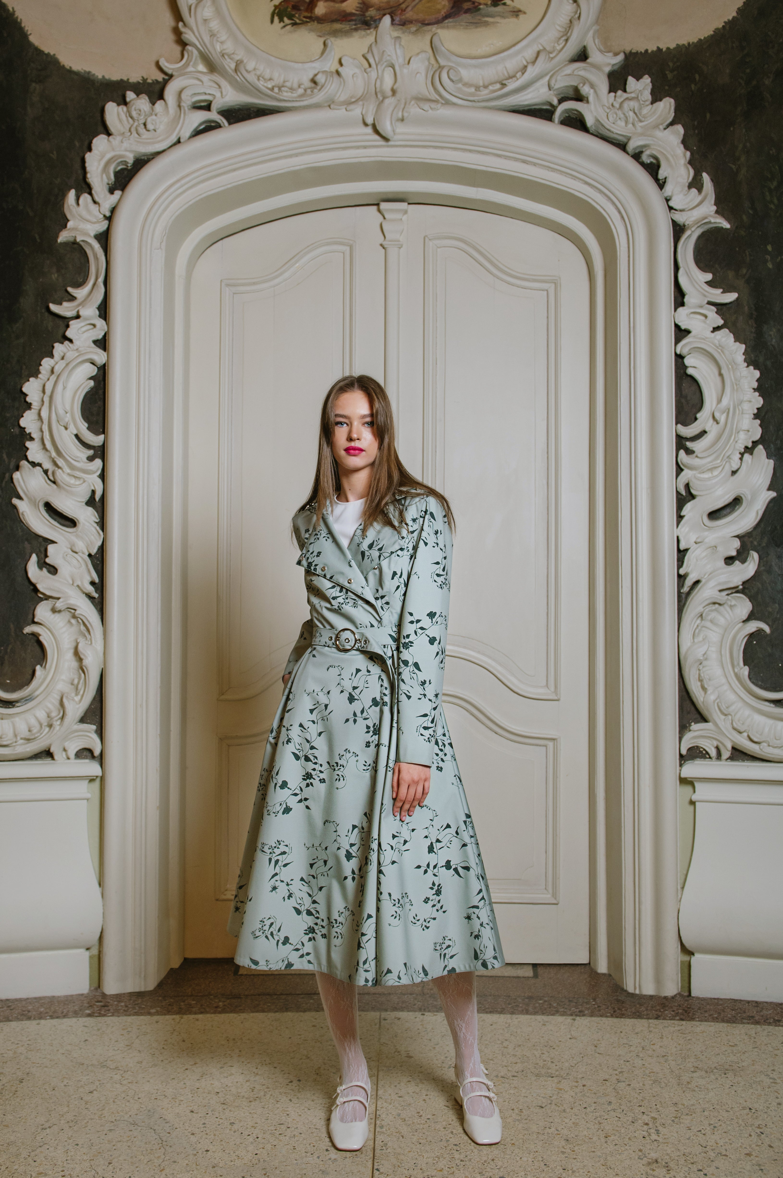 mint green coat with dark green floral print