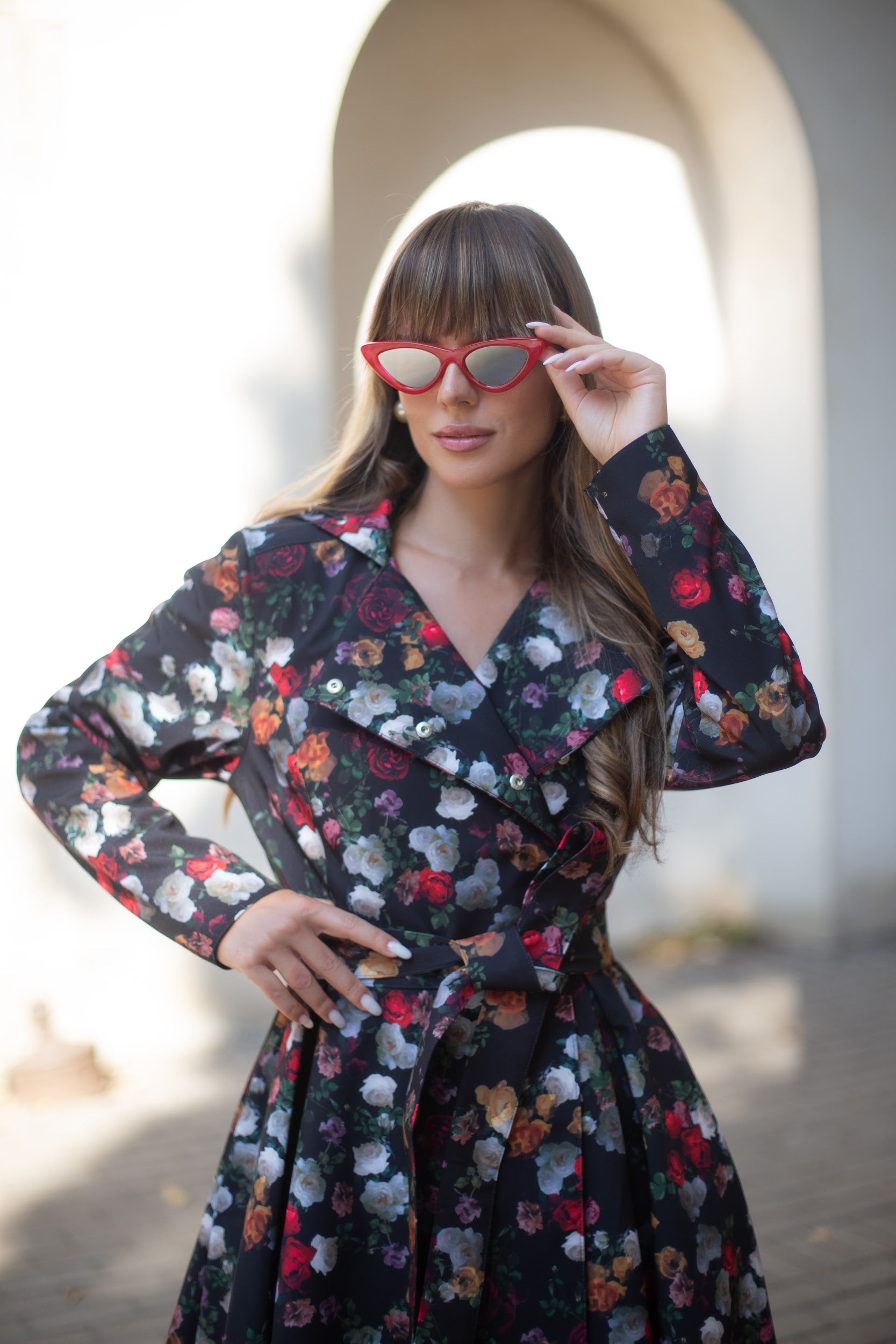 Close-up of vintage rose print on Rose Garden coat – vibrant florals on black background.
