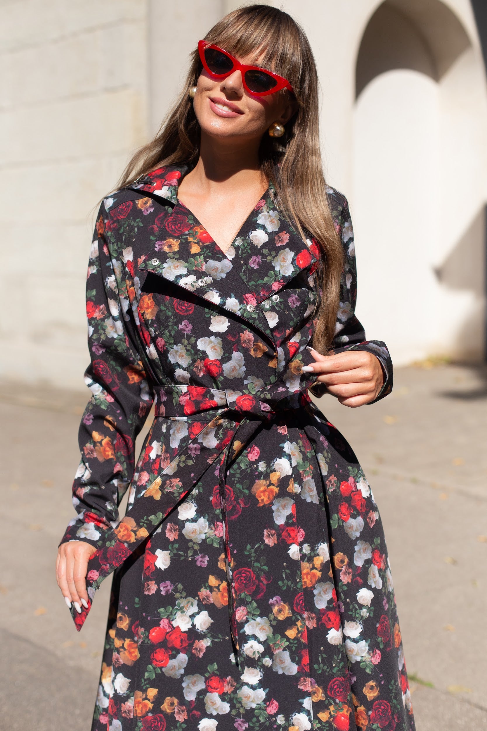 Model wearing floral Rose Garden coat – tailored silhouette with snap buttons and hidden side pockets