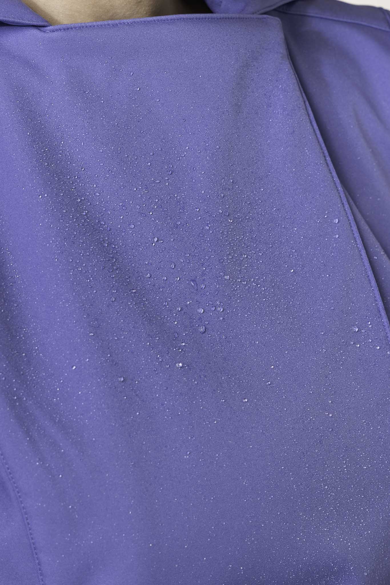 Close-up of powder blue tailored fabric on women's designer trench coat