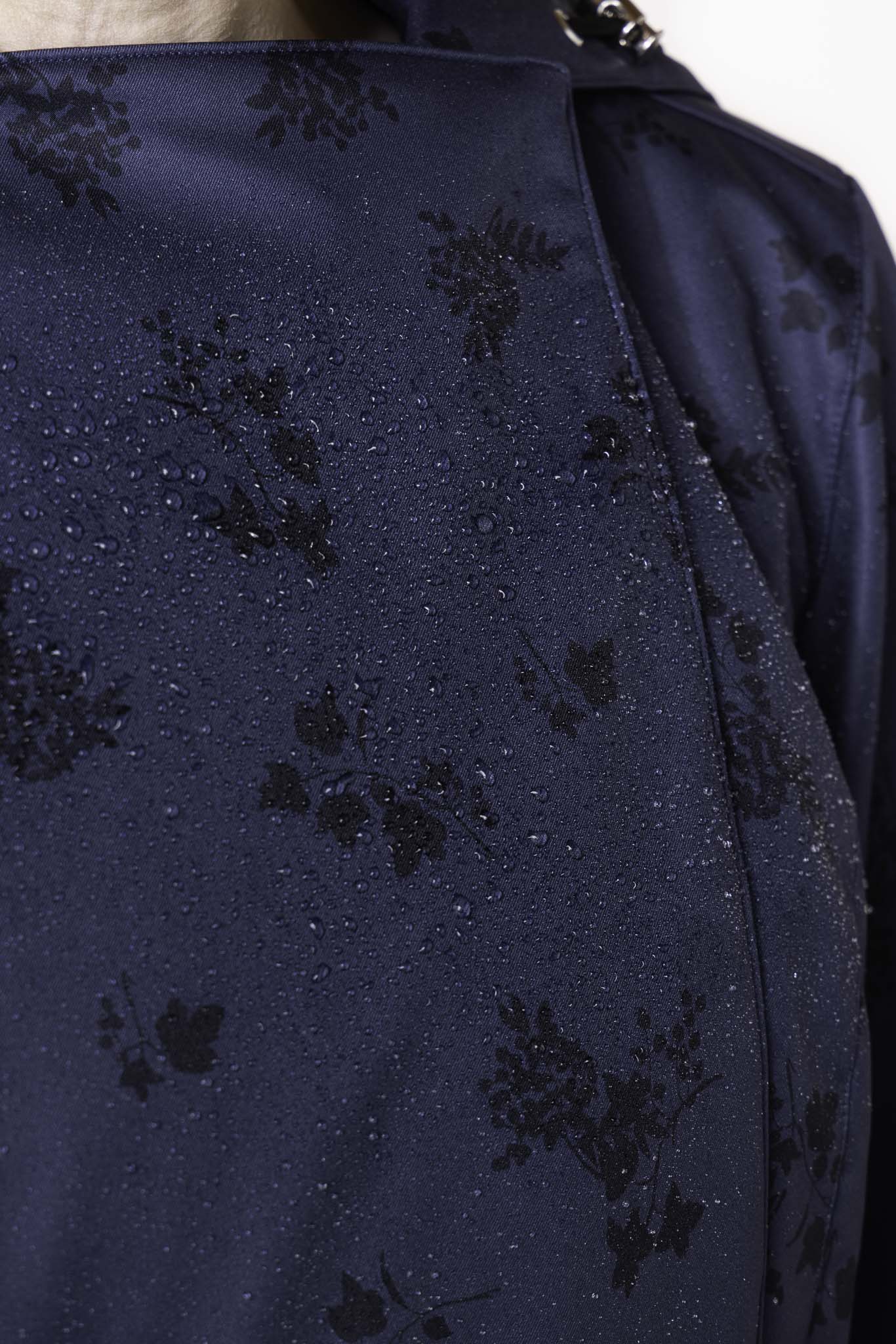 Black floral pattern detail on deep navy women's designer trench coat