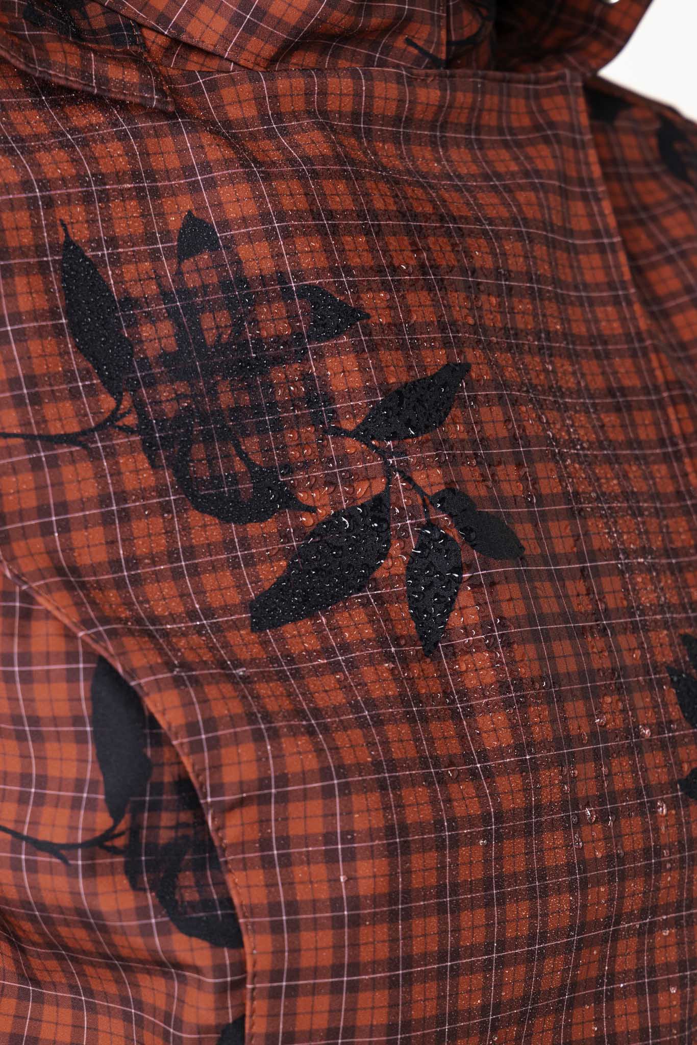Plaid and small floral print detail on crimson red waterproof softshell women's jacket fabric