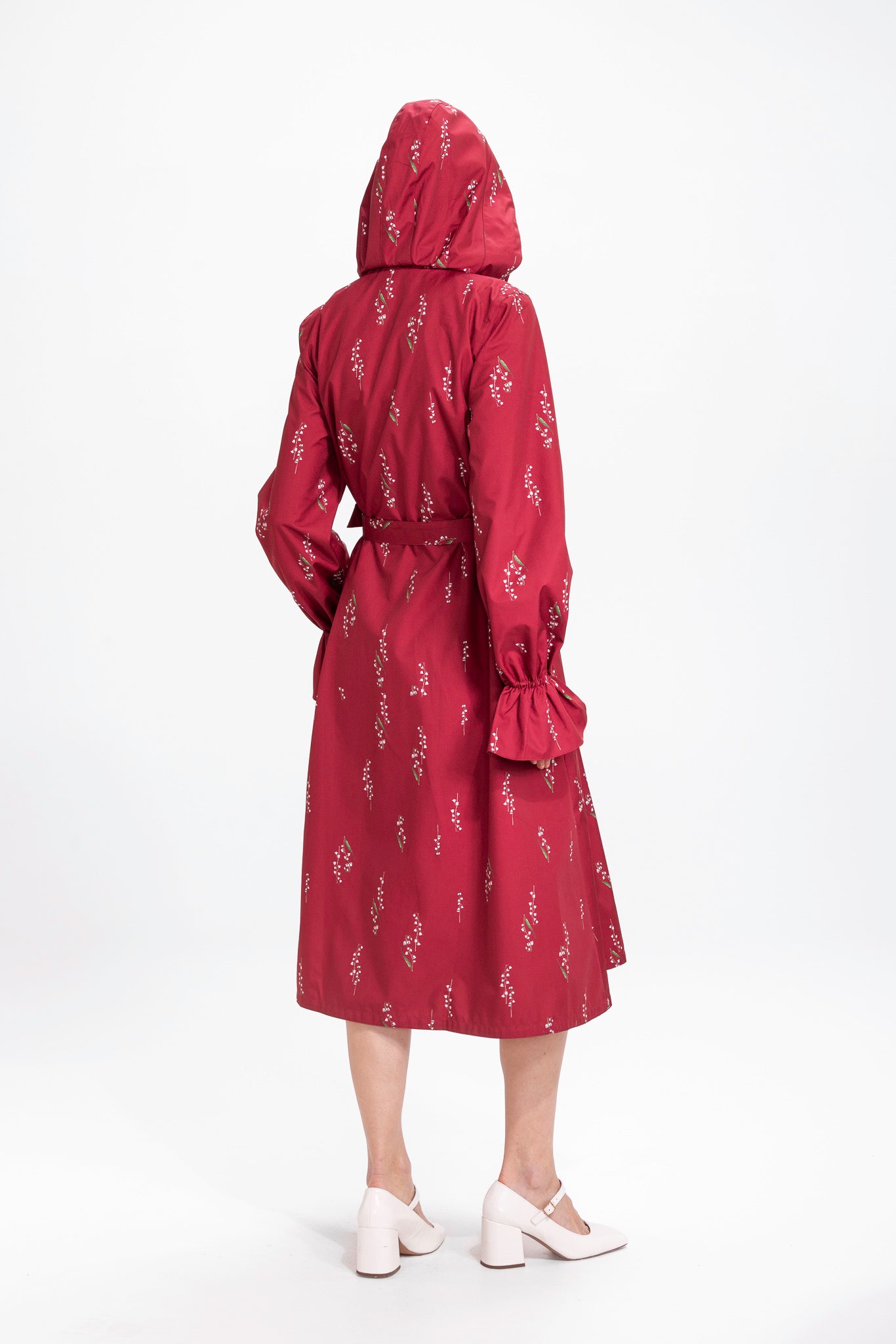 Back view of burgundy floral waterproof women's coat with gathered sleeves