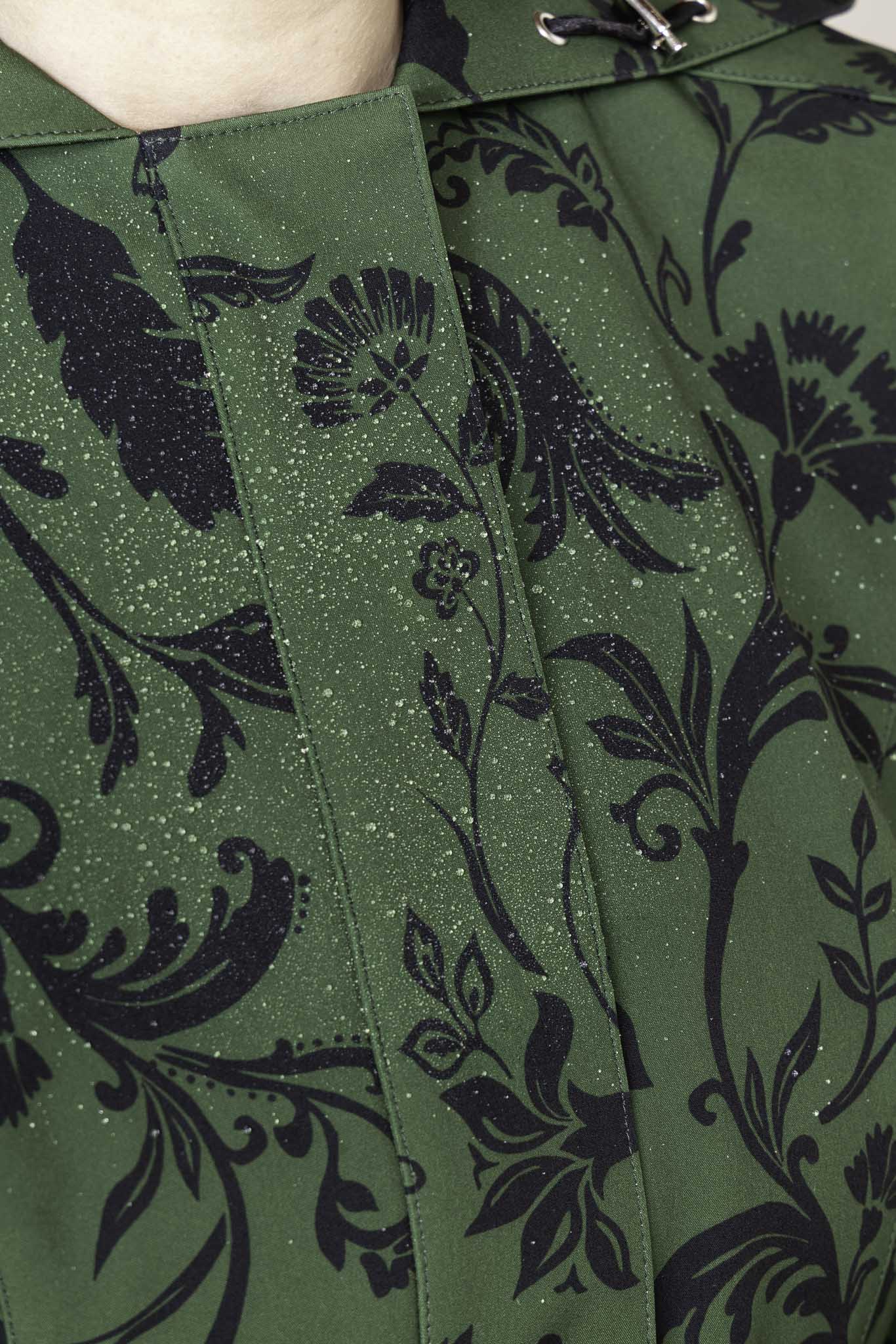 Close-up of dark green floral pattern on women's designer fit and flare coat