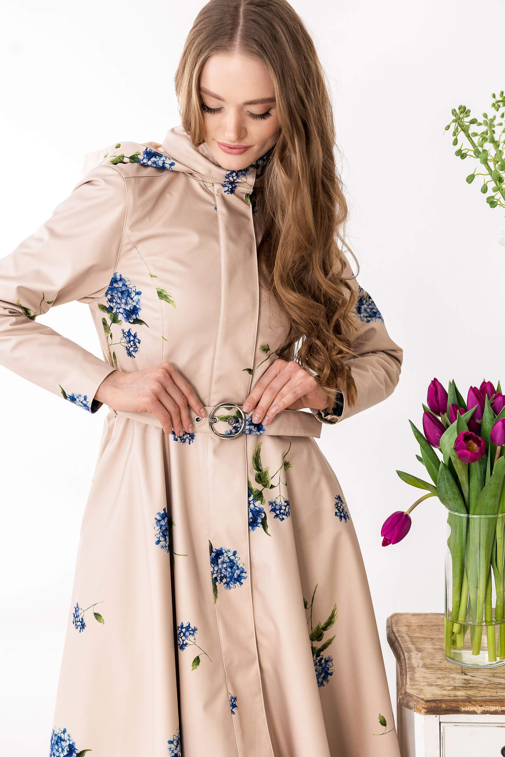Woman wearing a beige coat with floral pattern
