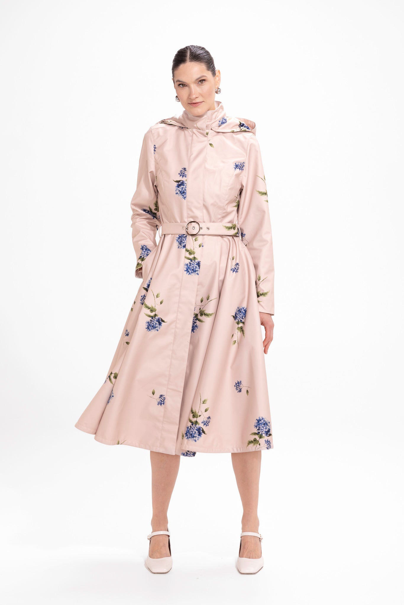 Model in motion wearing beige waterproof coat with elegant A-line skirt