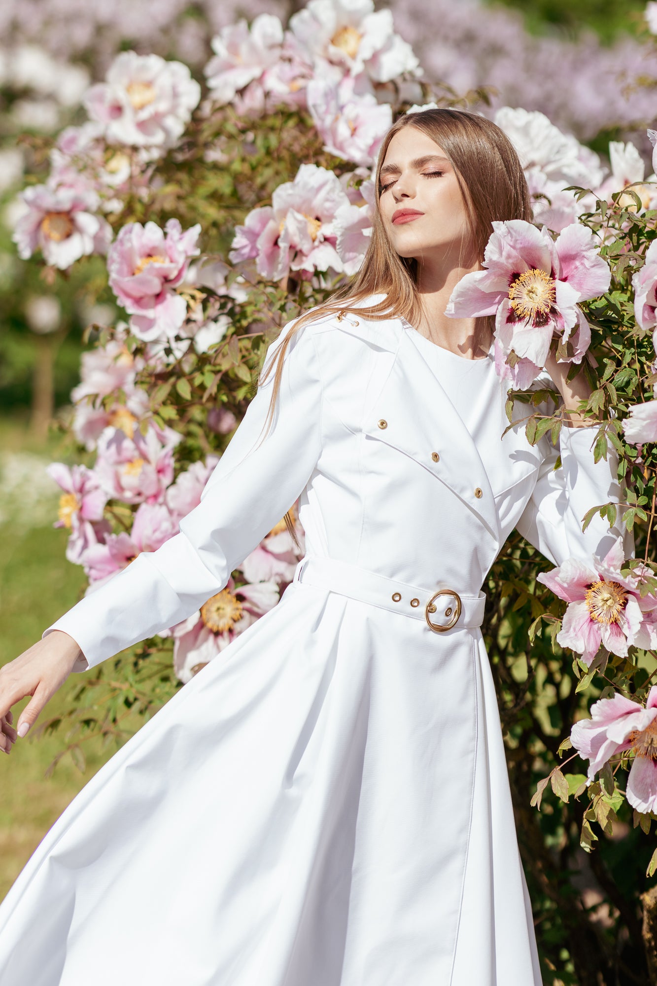 Lightweight white waterproof trench coat worn as chic wedding day and special occasion outerwear