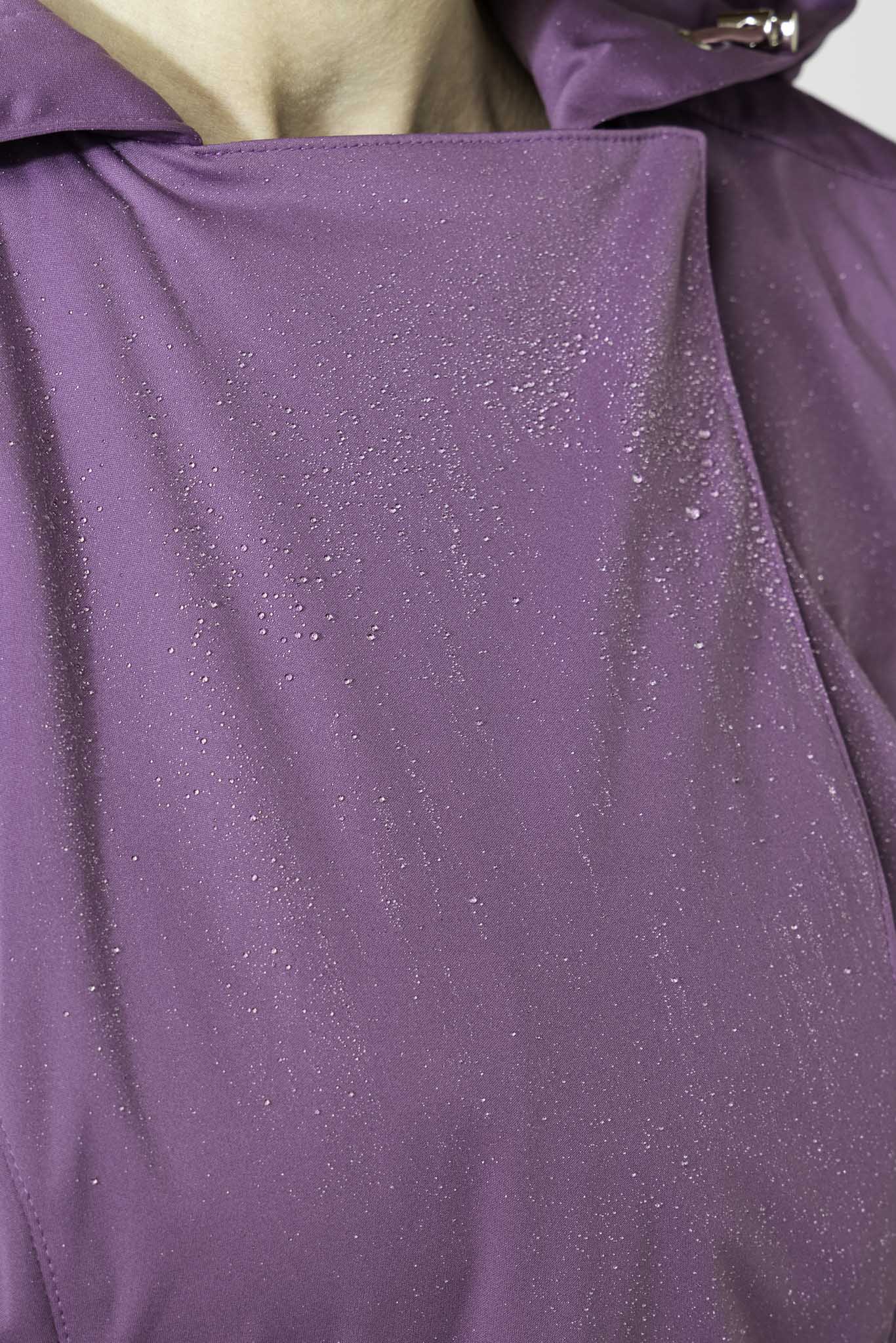 Water droplets on violet waterproof trench coat fabric showing water resistance