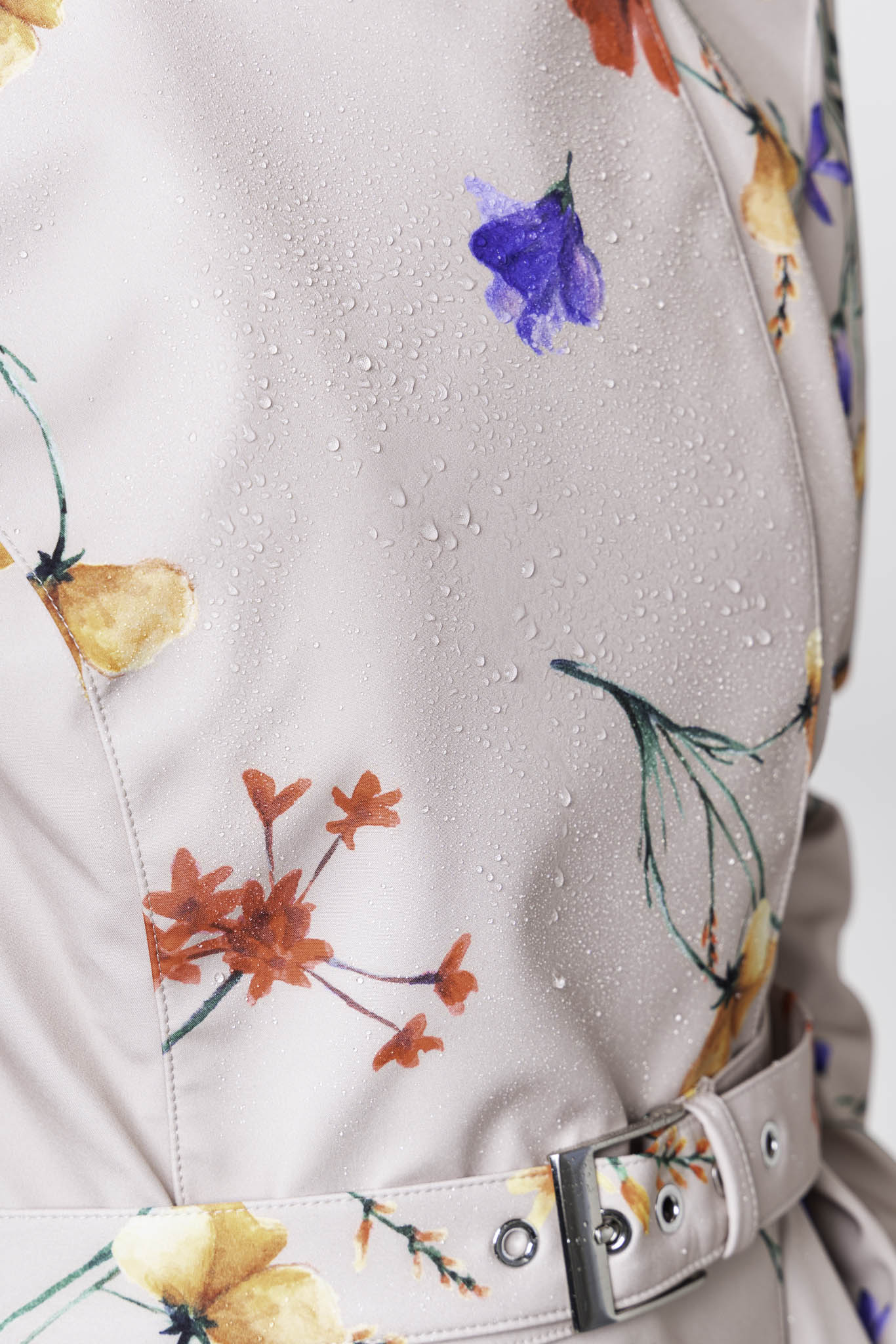 Blue, red, violet and golden yellow flower print detail on waterproof beige women's designer trench coat