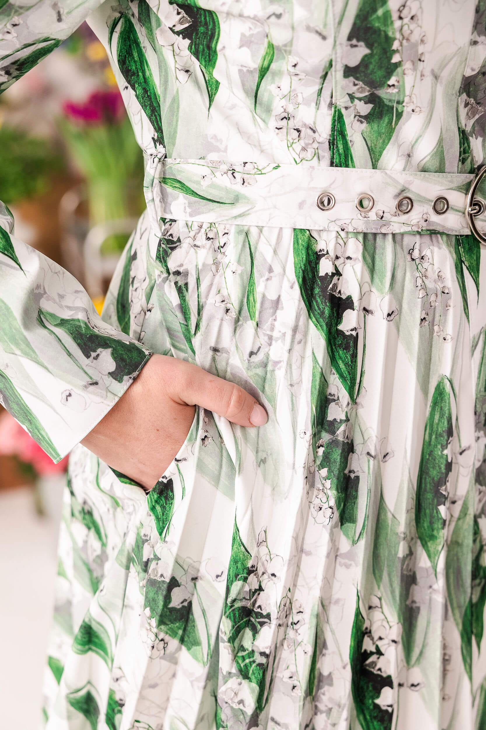 Soft green floral coat with delicate white blossoms and hidden side pockets