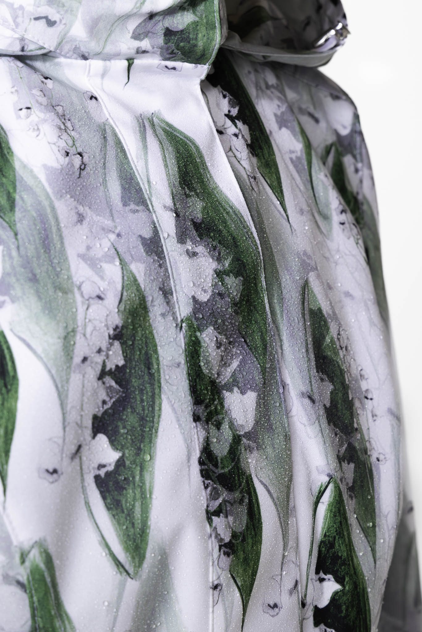 Water droplets on white-green waterproof coat fabric demonstrating water resistance