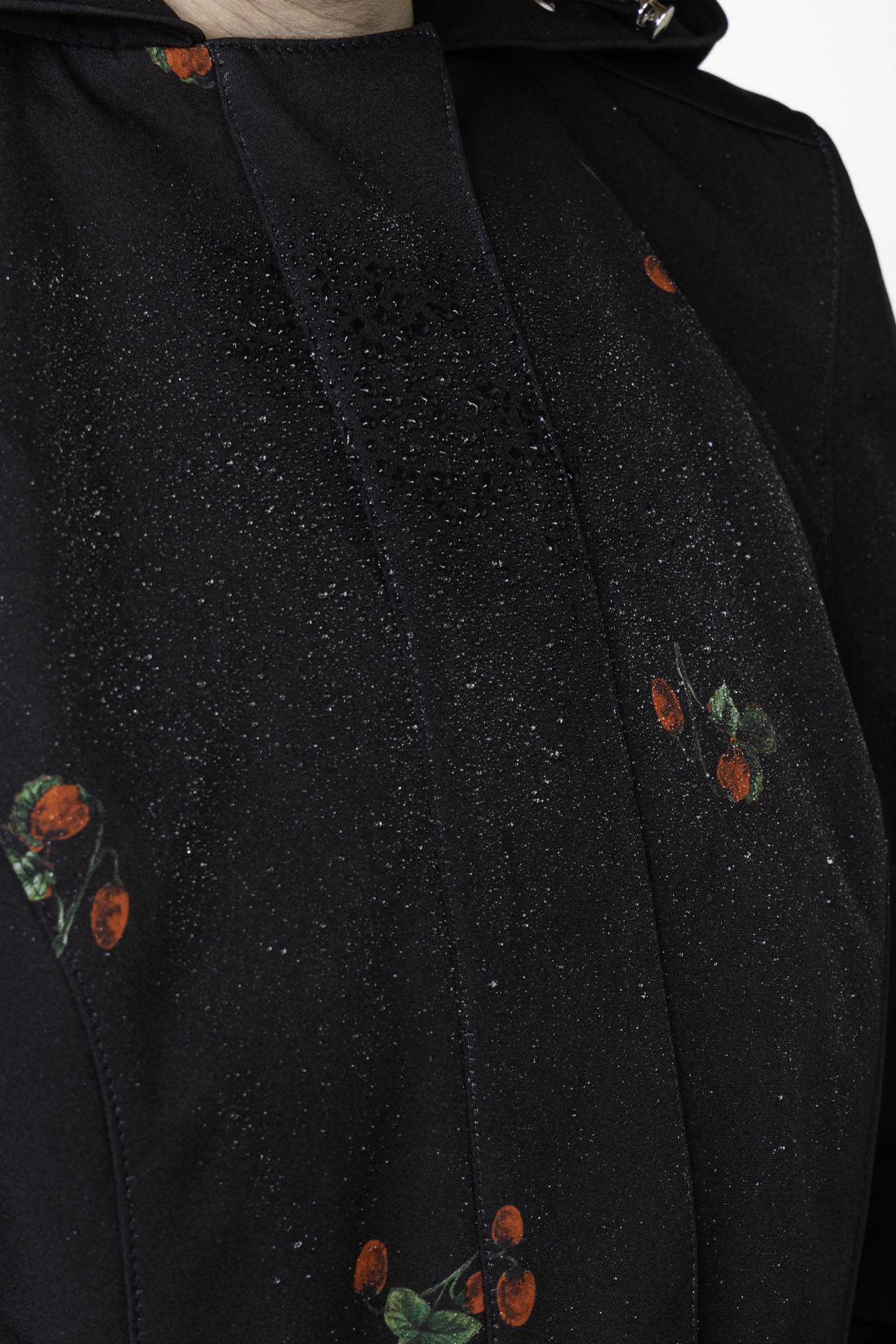 Bold strawberry print detail on black women's designer fit and flare coat