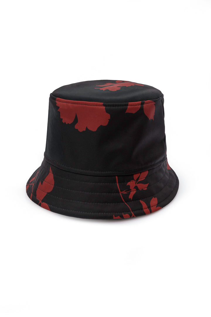 A black bucket hat with a red floral pattern, photographed against a solid white background.