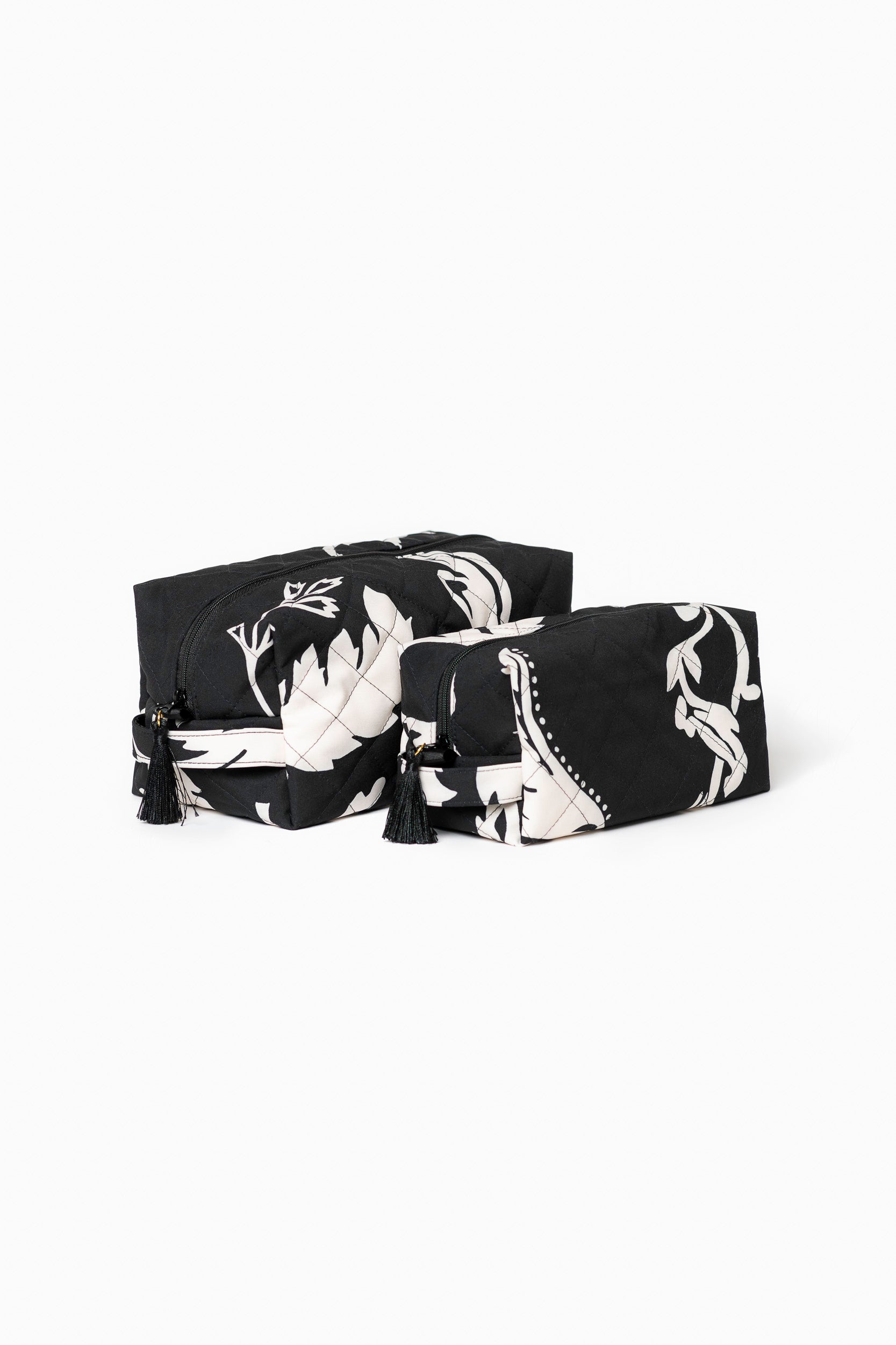Black makeup bag set with white floral print for makeup, toiletries, and travel essentials