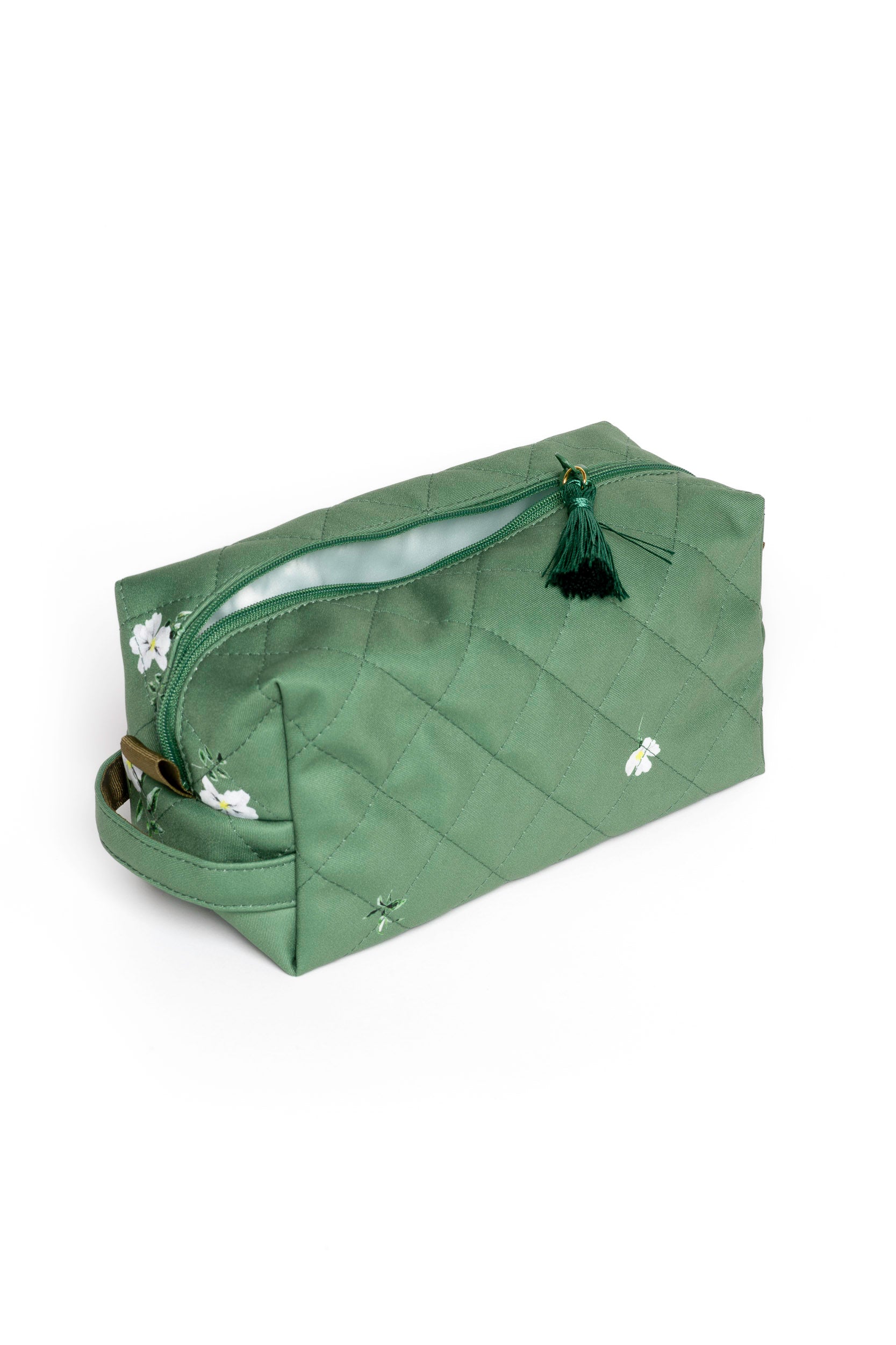 Small soft green floral makeup pouch opened to reveal mint lining and compact storage for beauty essentials
