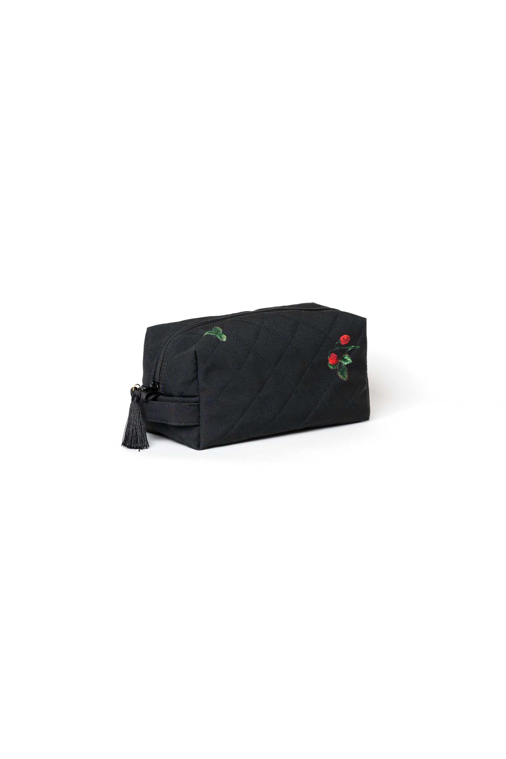 Small black cosmetic bag with strawberry print, black zipper, and tassel detail for makeup, skincare, and travel accessories