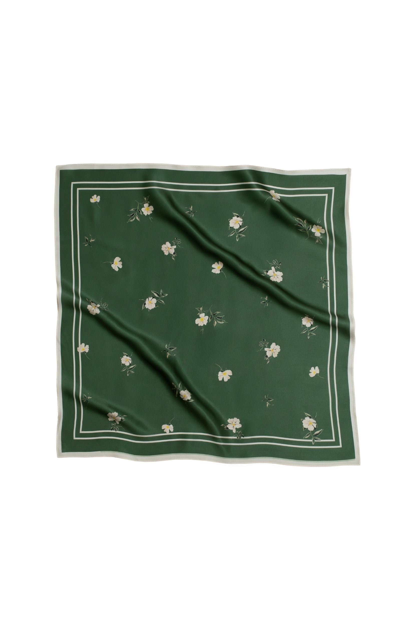 Green square scarf with floral patterns on a white background