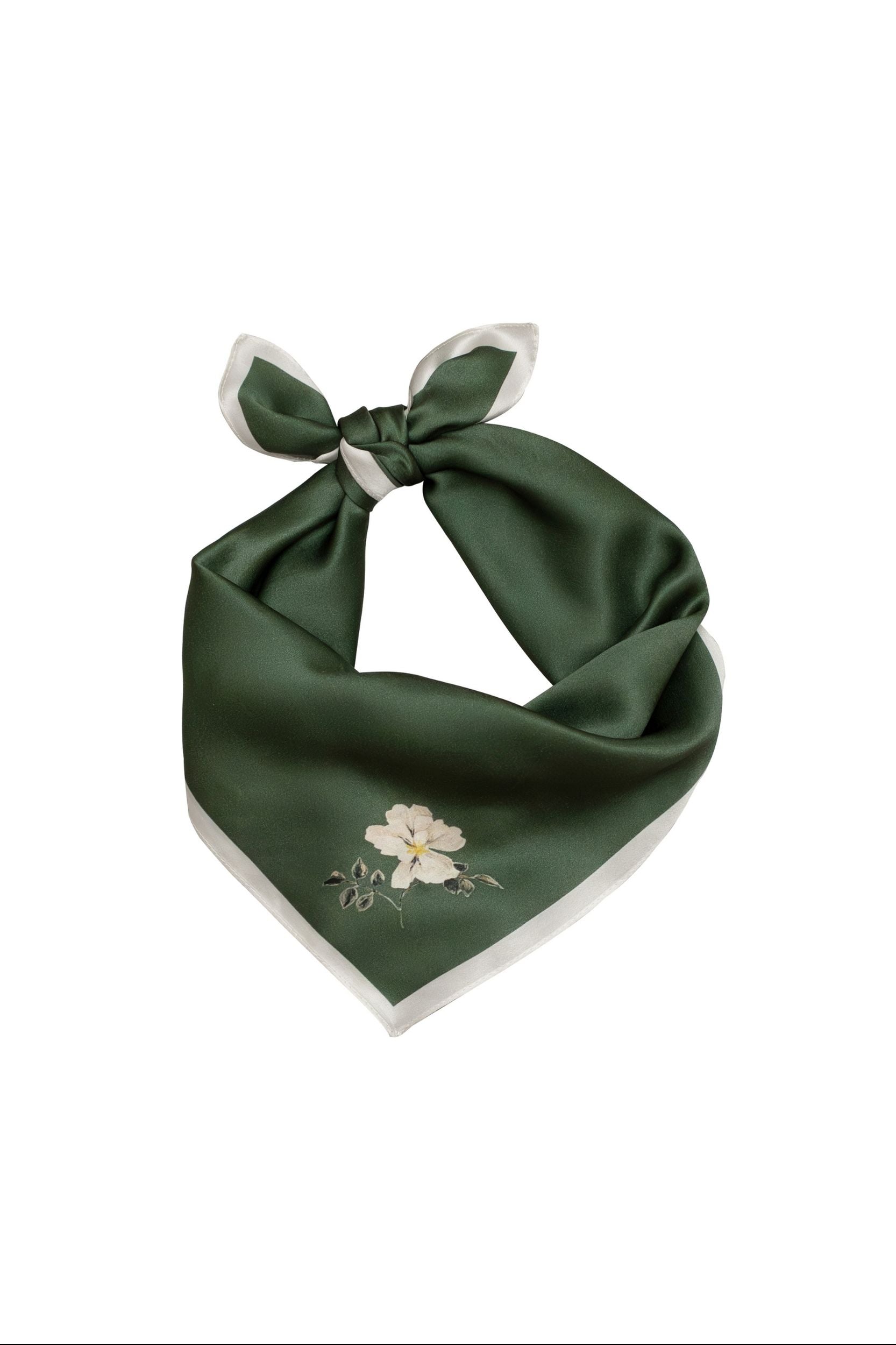 Green scarf with floral design and white knot on a white background