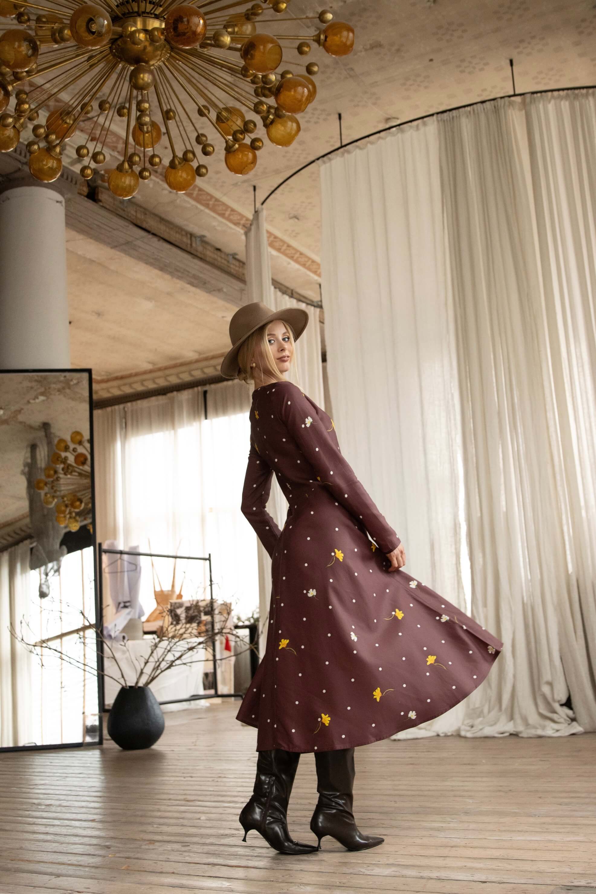 Brown midi dress with floral and polka dot print, featuring practical side pockets and hidden back zipper.