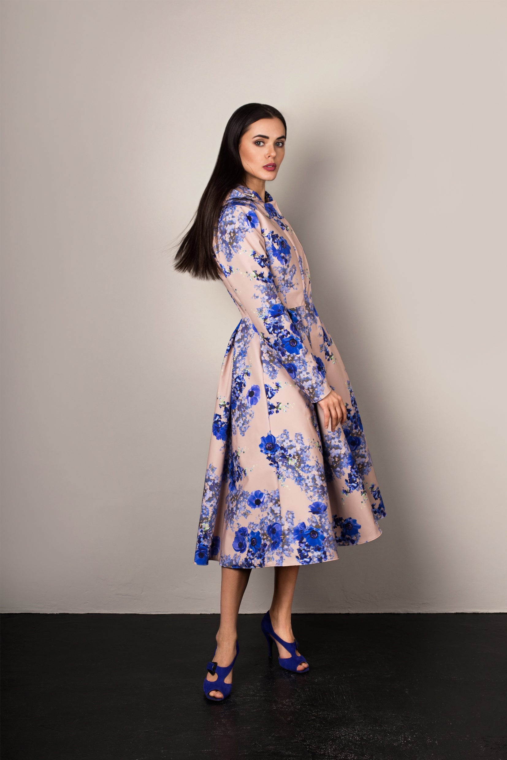 Side view of Cornflower Blue coat – tailored waist and flared hemline with hidden pockets.