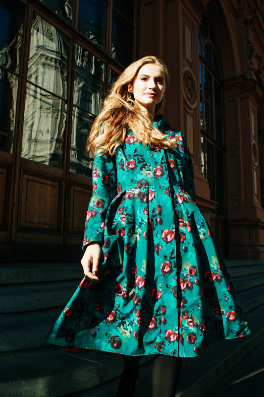 Waterproof design coat Rosalie by RainSisters: Red Rose pattern on emerald green background