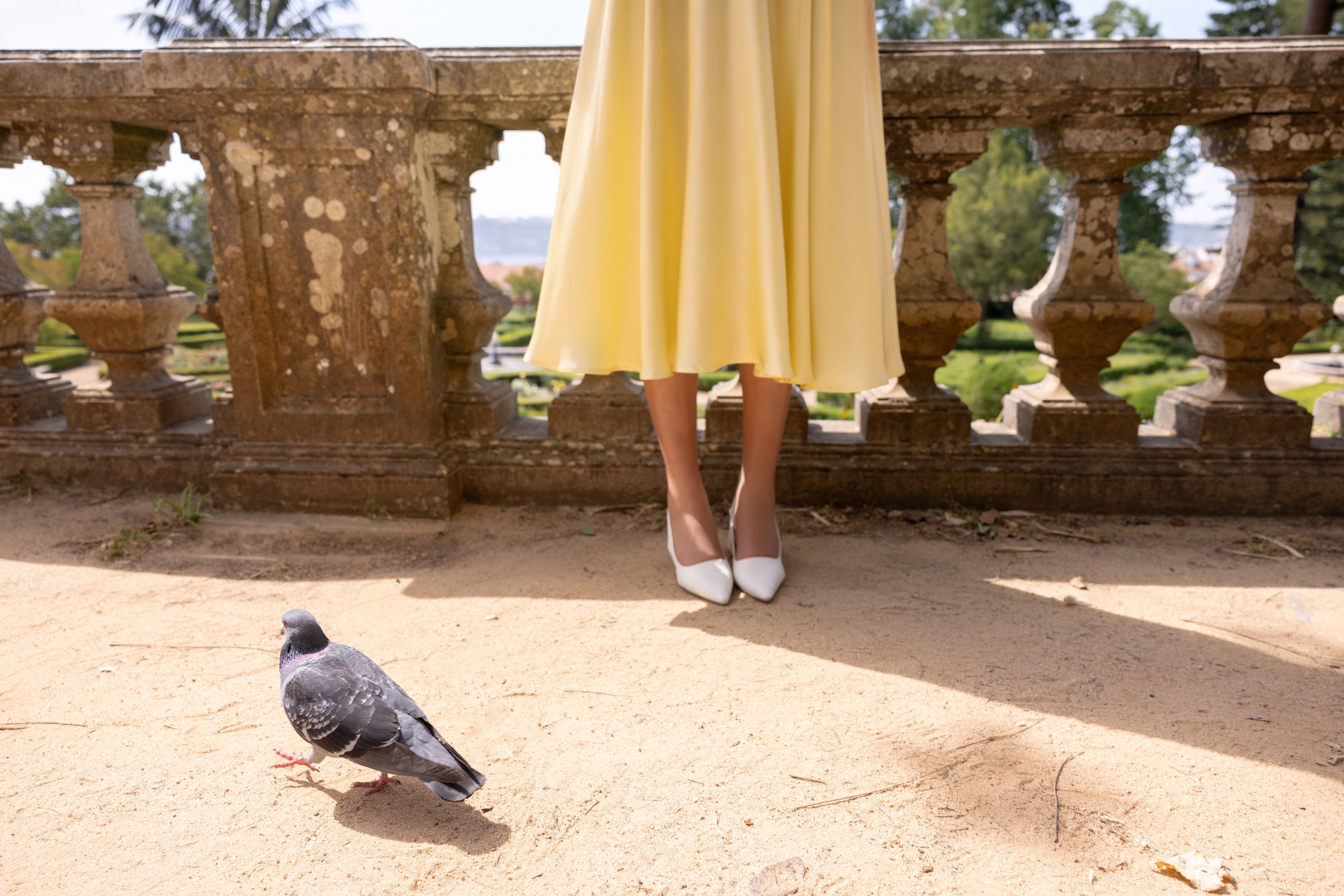 Model wearing RainSisters butter yellow dress Vanilla Sunbeam styled with white shoes