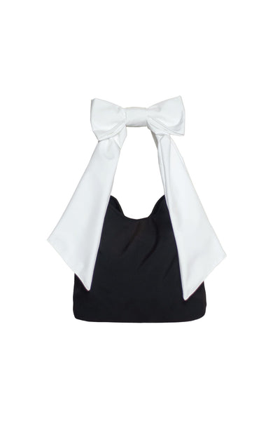 Black Moonlight tote bag with white shoulder straps and bow detail, durable water-resistant fabric.