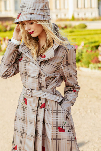 Woman wearing a plaid coat with red floral pattern in an outdoor setting