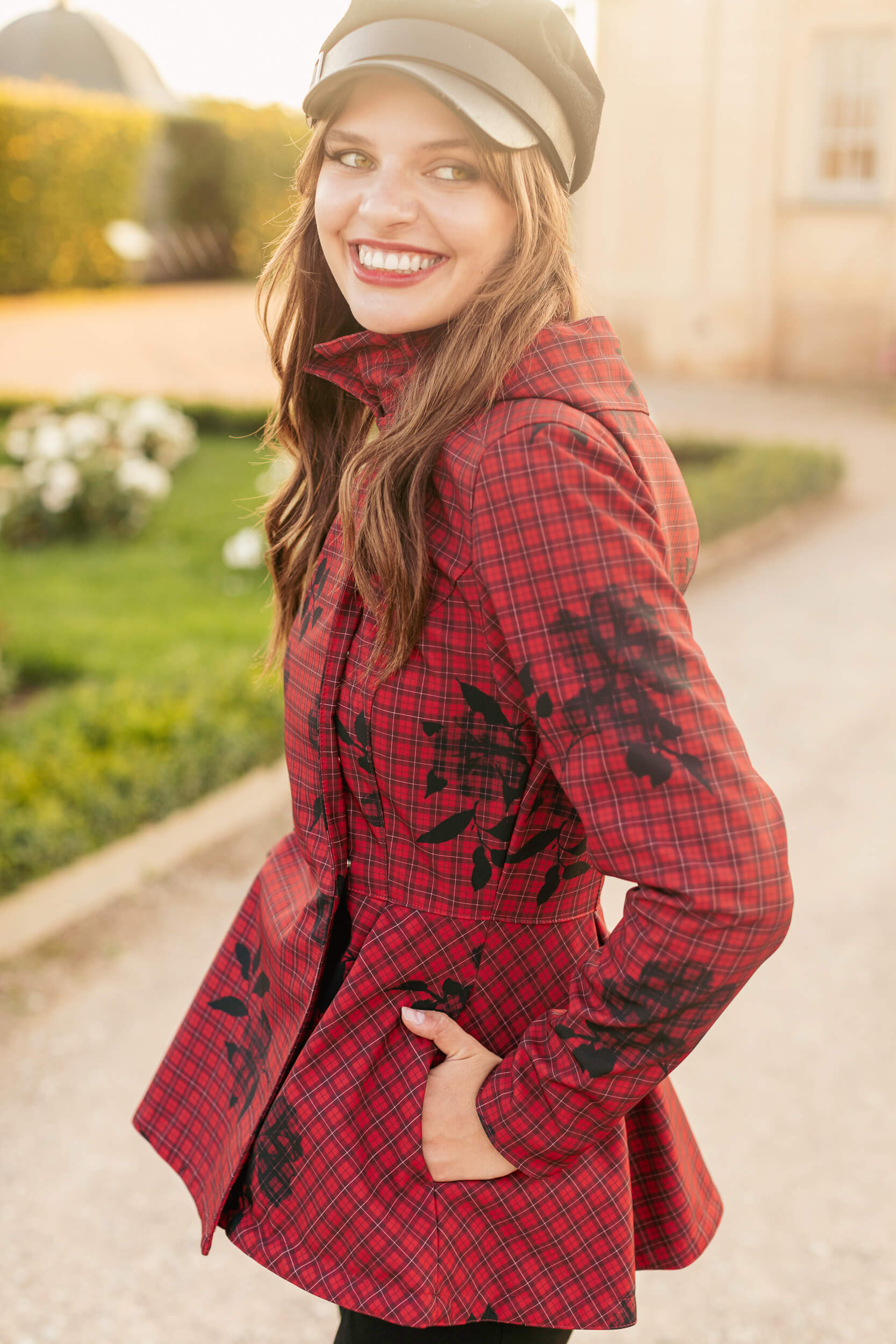 Smiling in the Crimson Heart jacket, showing its rich deep red tone.