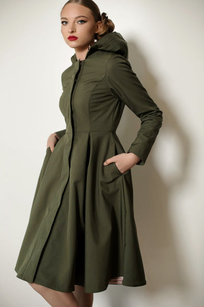 Close-up of Moss Green coat details: snap buttons, and waterproof khaki green fabric.