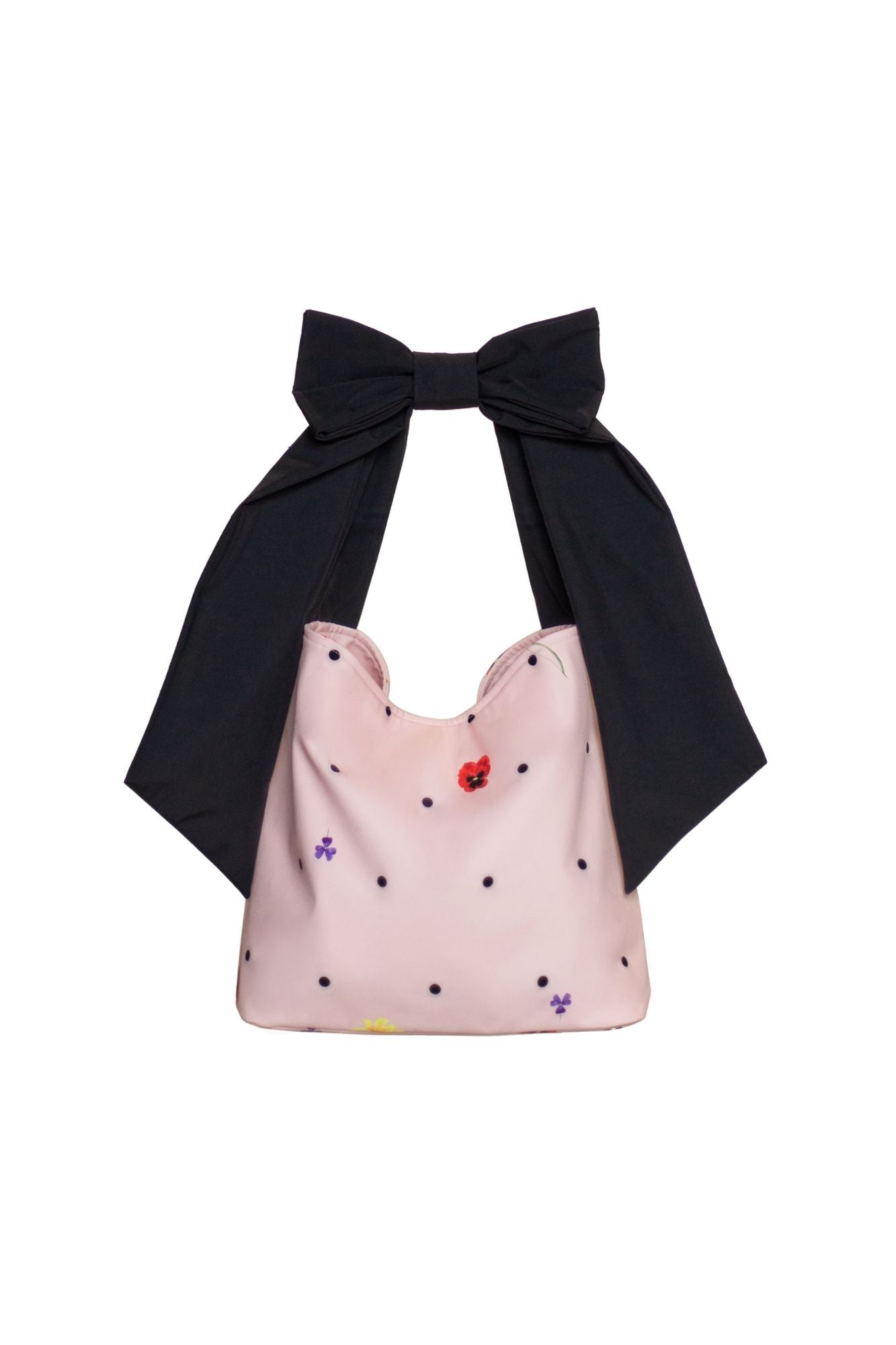 Soft pink tote bag with colorful floral pattern and playful bow strap, combining dreamy charm with everyday practicality.
