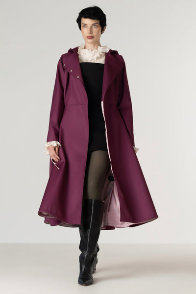 Women's deep burgundy double-breasted trench coat opened to reveal smooth ashy pink Italian satin lining.