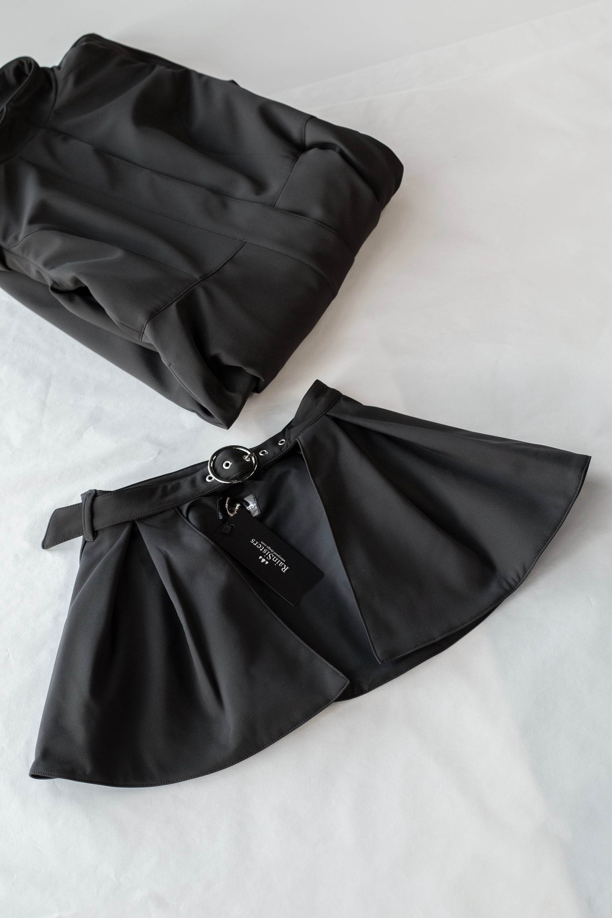 Solid black belt with peplum detail and silver tone hardware