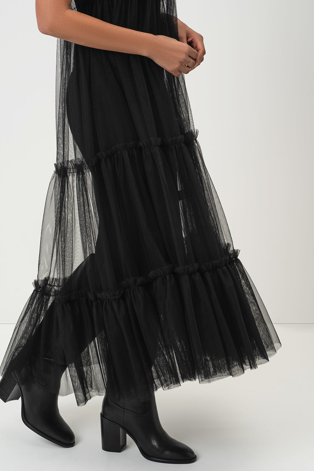 RainSisters black tiered tulle maxi dress Sheer Romance worn by a model, paired with black leather block-heel ankle boots, shown against a plain white studio background.