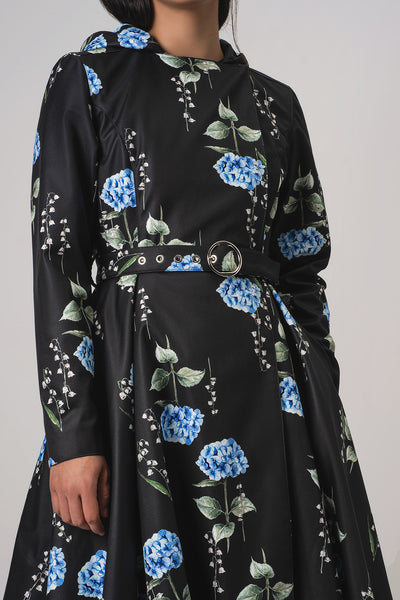 RainSisters black long-sleeve coat Flower Moon with a blue and green floral print, featuring a matching belt with silver hardware, shown on a model against a light gray background.