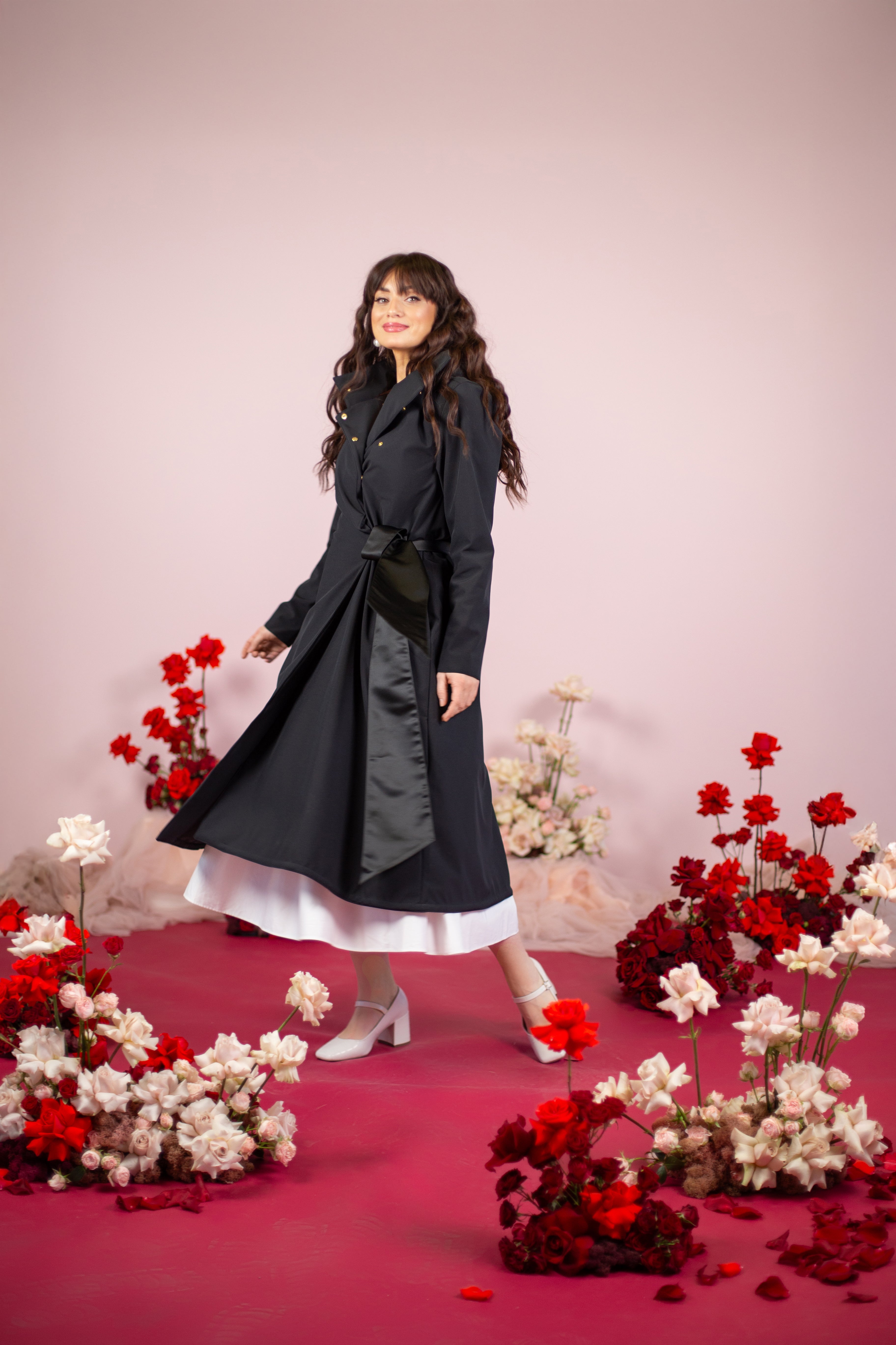 Elegant A-line coat with a sewn-on belt, water-resistant fabric, and a detachable hood.