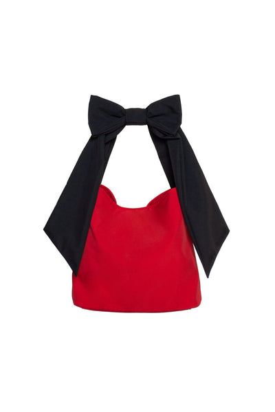 Elegant red tote bag with delicate bow on a black strap, designed for a classy, confident look.