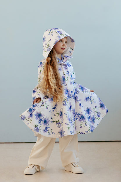 fitted and flared girls' coat is white with beautiful blueish flowers