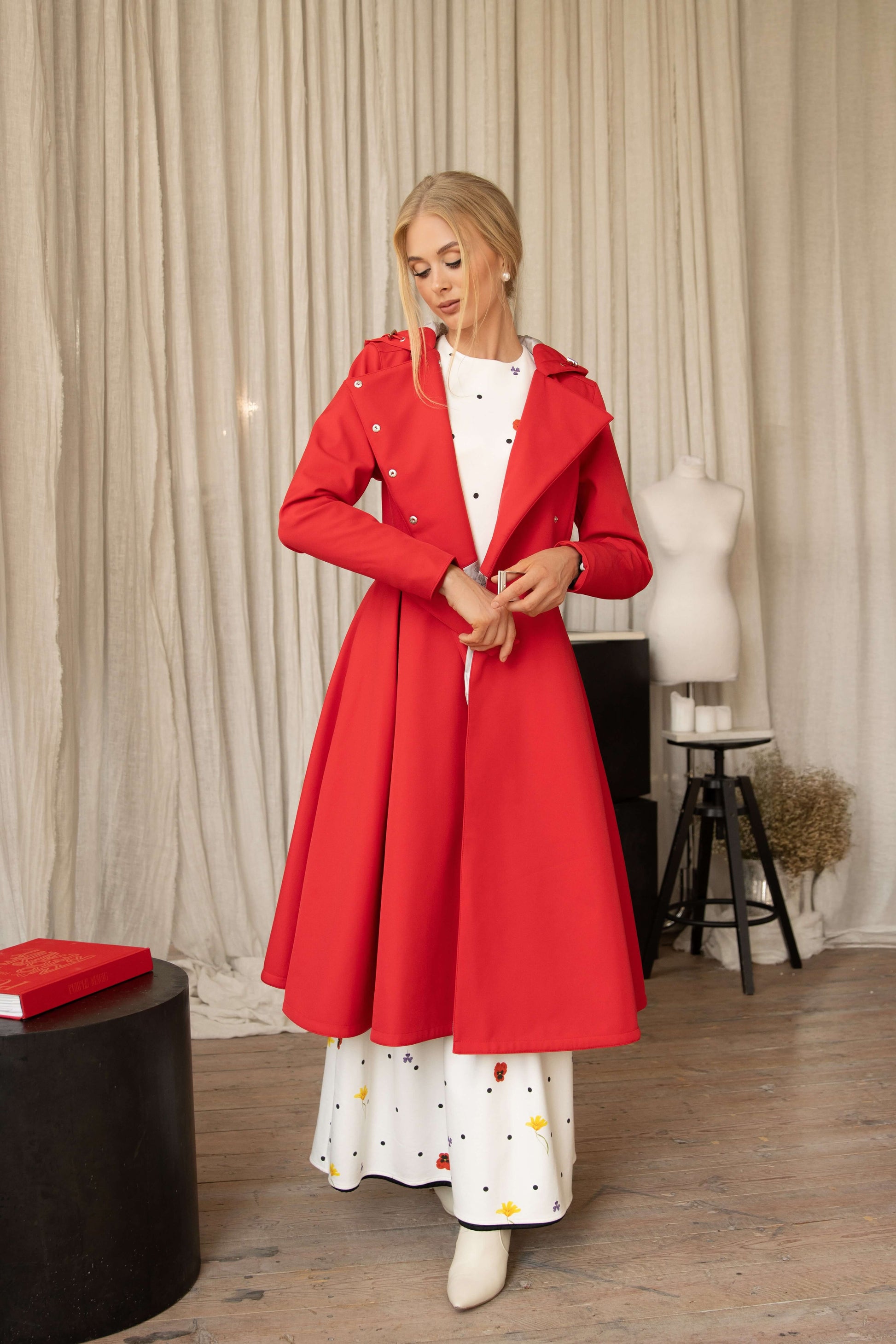 Model wearing a red coat Queen of Hearts by RainSisters in an indoor setting.