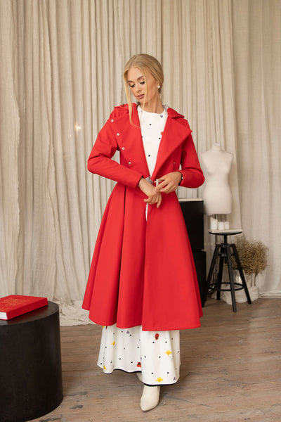 Model wearing a red coat Queen of Hearts by RainSisters in an indoor setting.
