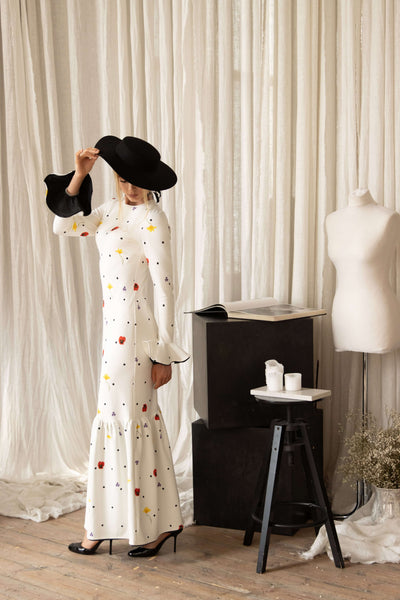 Elegant long sleeve floral maxi dress with black polka dots, flattering slim silhouette and flared hem, ideal for weddings or evening events.