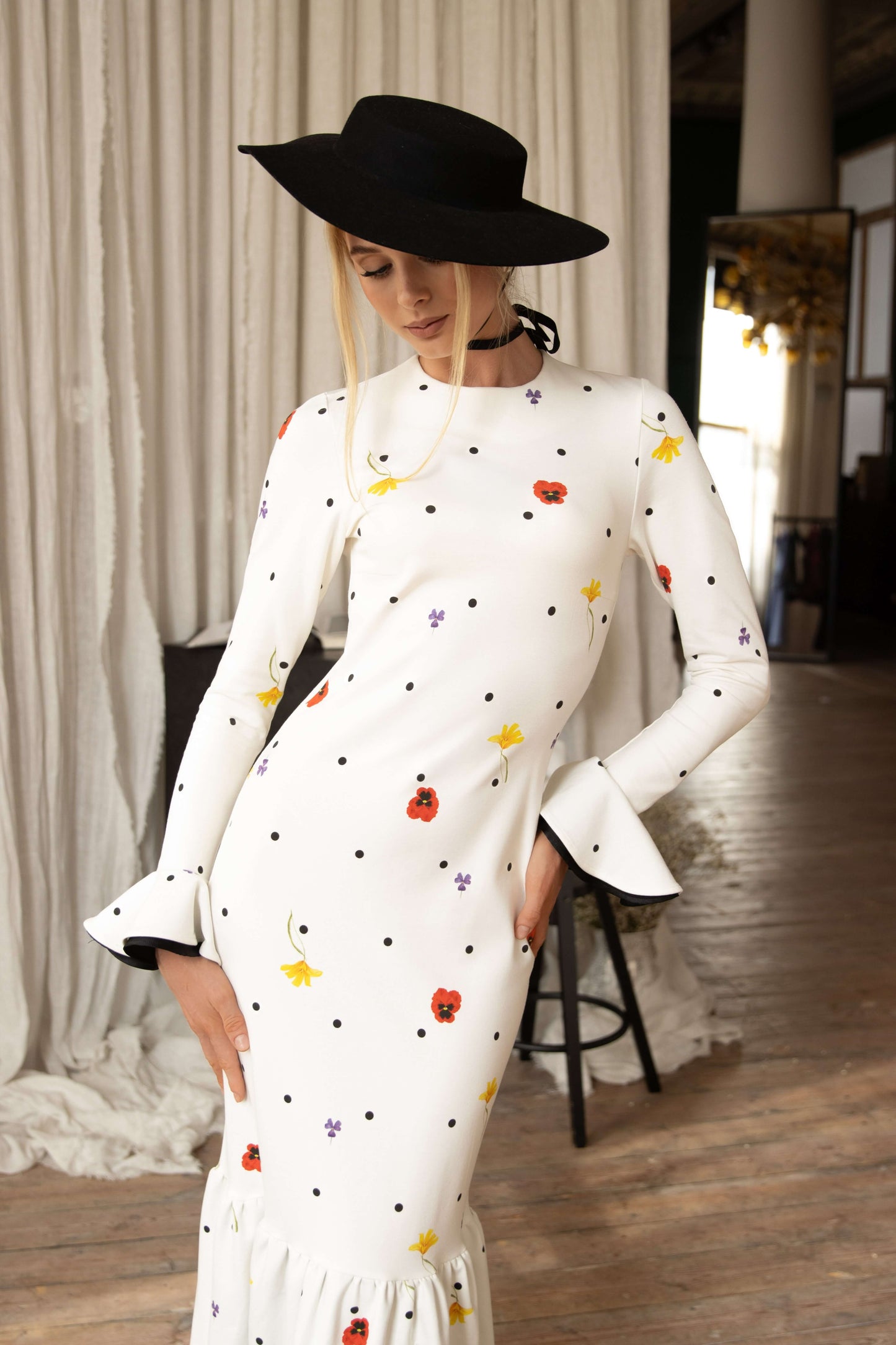 Dancing Romance white viscose maxi dress with black polka dots and floral print, slim fit bodice, flowing ruffled hem, perfect for special occasions.