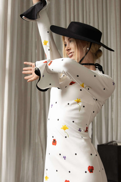 Maxi dress with ruffled hem, long sleeves, black polka dots, and floral design, made from luxurious white viscose for elegant occasions.