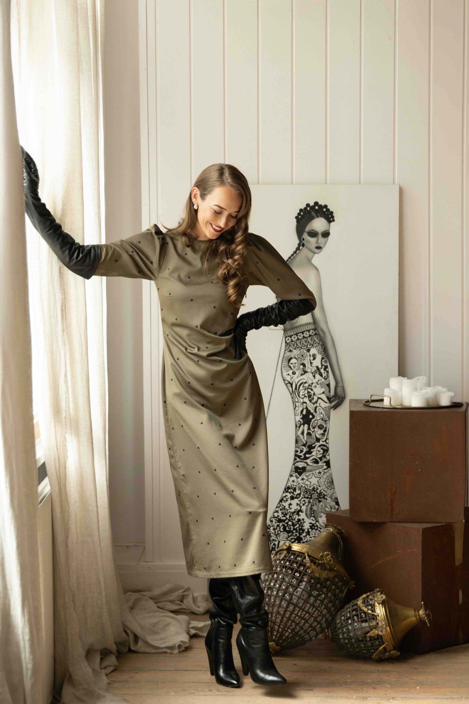 Chic tencel satin midi dress featuring delicate back cutout with ribbon tie and high neckline for vintage elegance.