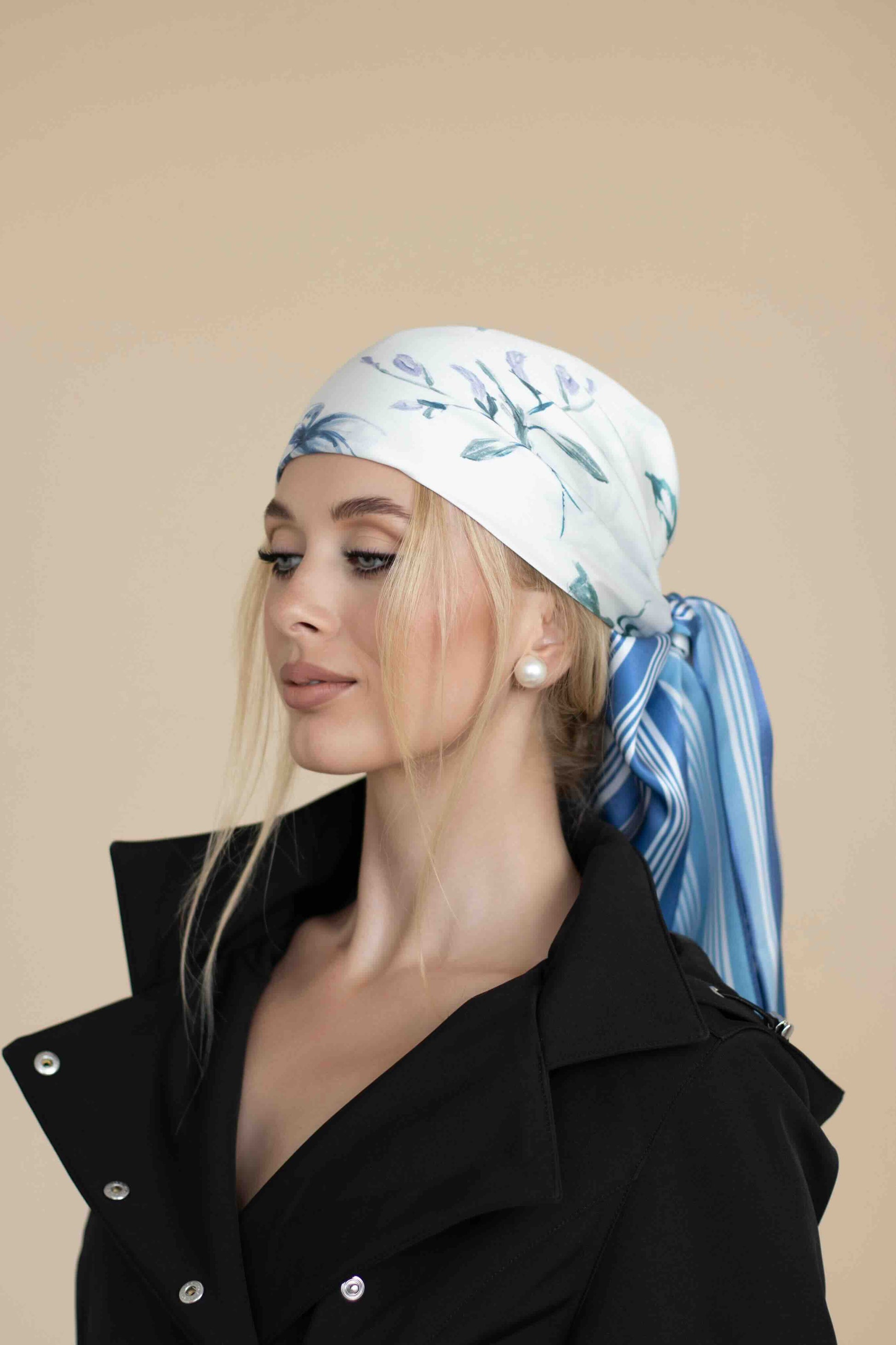 Woman wearing a floral headscarf with a beige background