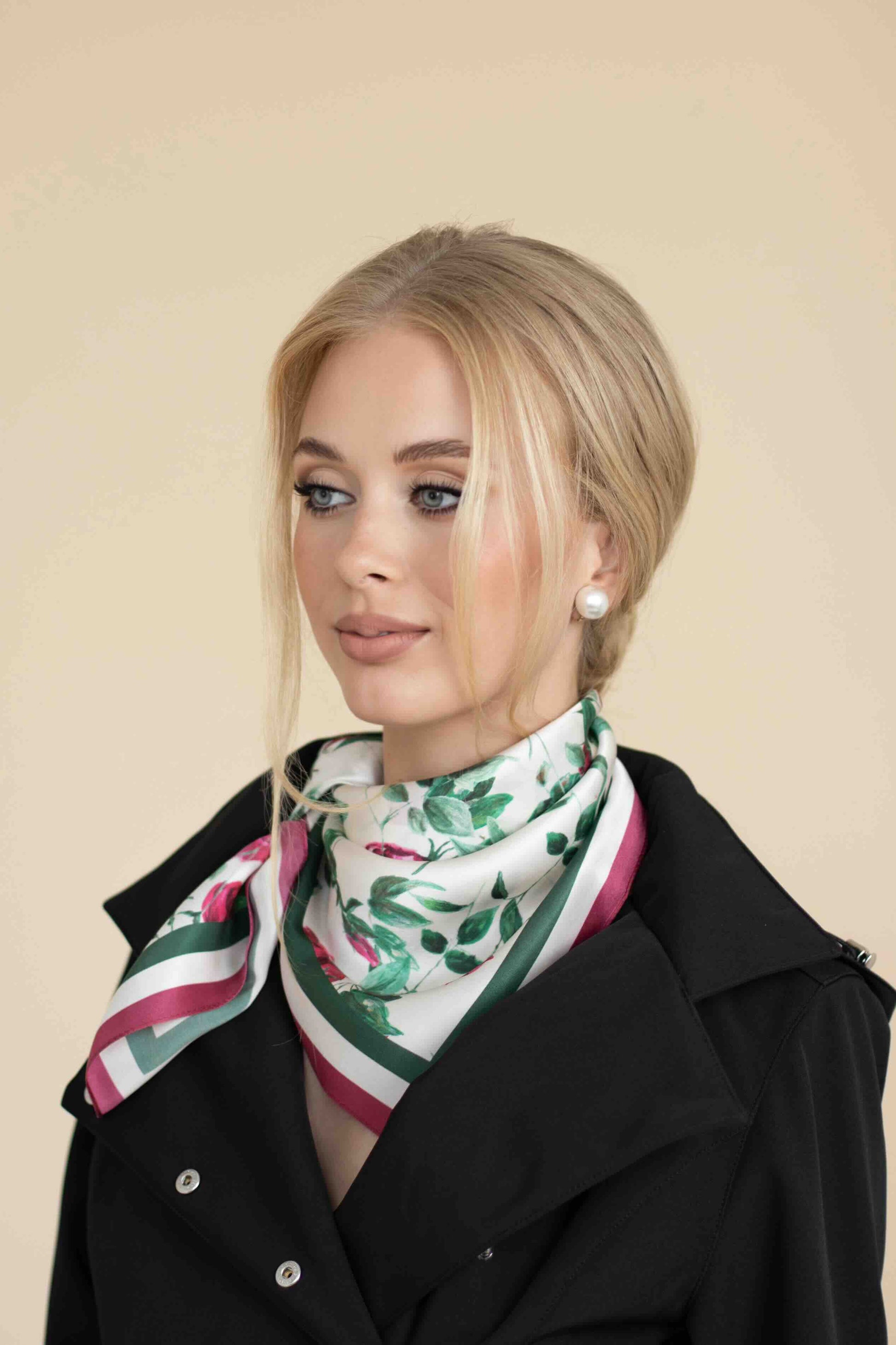 Woman wearing a floral scarf with a beige background