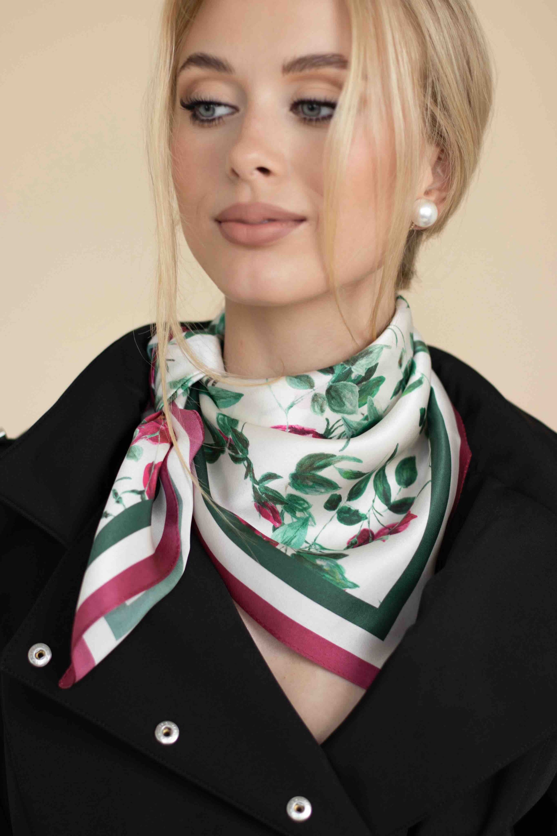 Woman wearing a floral scarf with a beige background